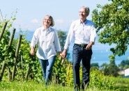 Older couple walking outside holding hands